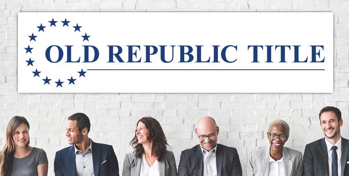 Group of 6 men and women standing side by side laughing against a white brick wall with the Old Republic Title logo sign on it 