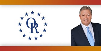 ORT logo with image of smiling man with gray hair wearing suit and light blue tie.
