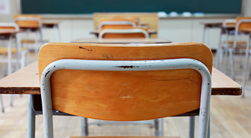 an image of an empty classroom with a bunch of desks