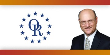 ORT logo with image of smiling bald man with glasses, wearing suit.