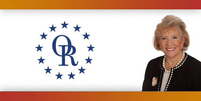 ORT logo with image of smiling blonde woman wearing black cardigan and pearl necklace.