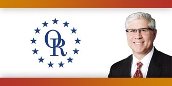 ORT logo with image of smiling man with gray hair and glasses, wearing a suit.