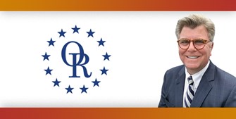 ORT logo with image of smiling man with gray hair and glasses, wearing blue suit.