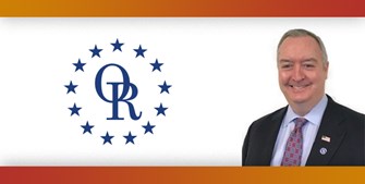 ORT logo with image of smiling man with gray hair in suit.