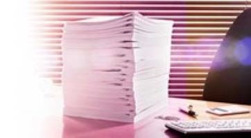 Stack of papers on a desk.
